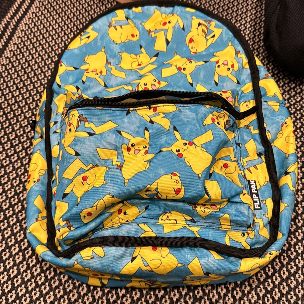 FREE with Pokemon purchase.  Reversible Pokemon backpack